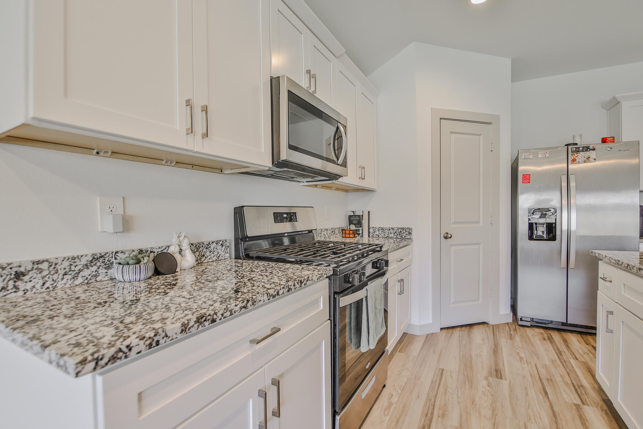 7406 9th Street Lubbock, TX 79416 - Photo 32 of 54 a kitchen with stainless steel appliances granite countertop a sink stove and refrigerator