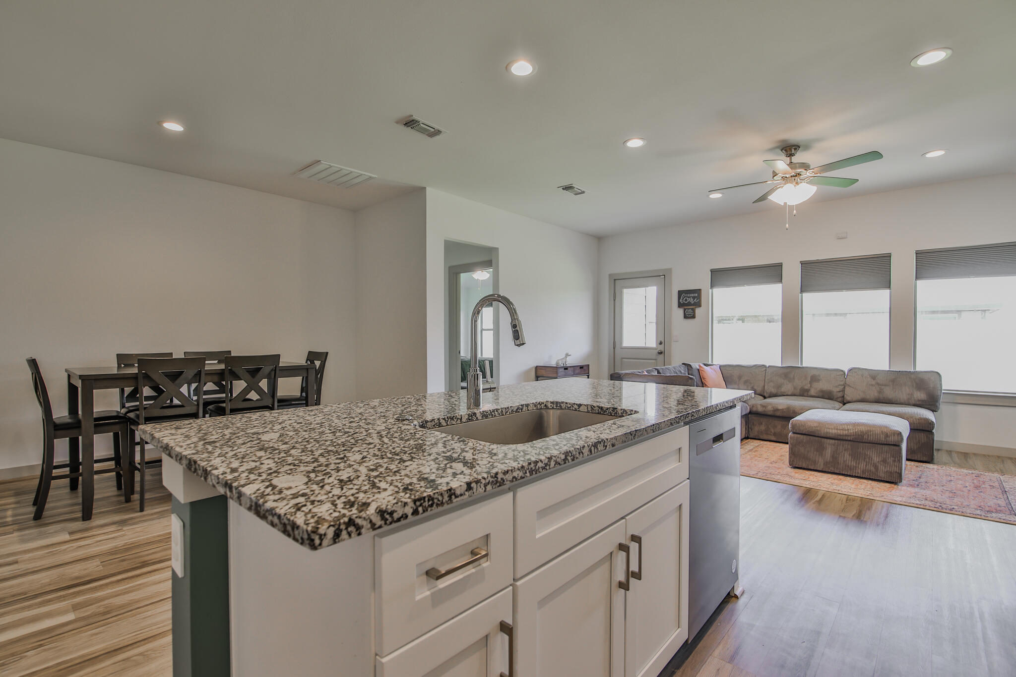 7406 9th Street Lubbock, TX 79416 - Photo 35 of 54 a kitchen with granite countertop a sink and stove