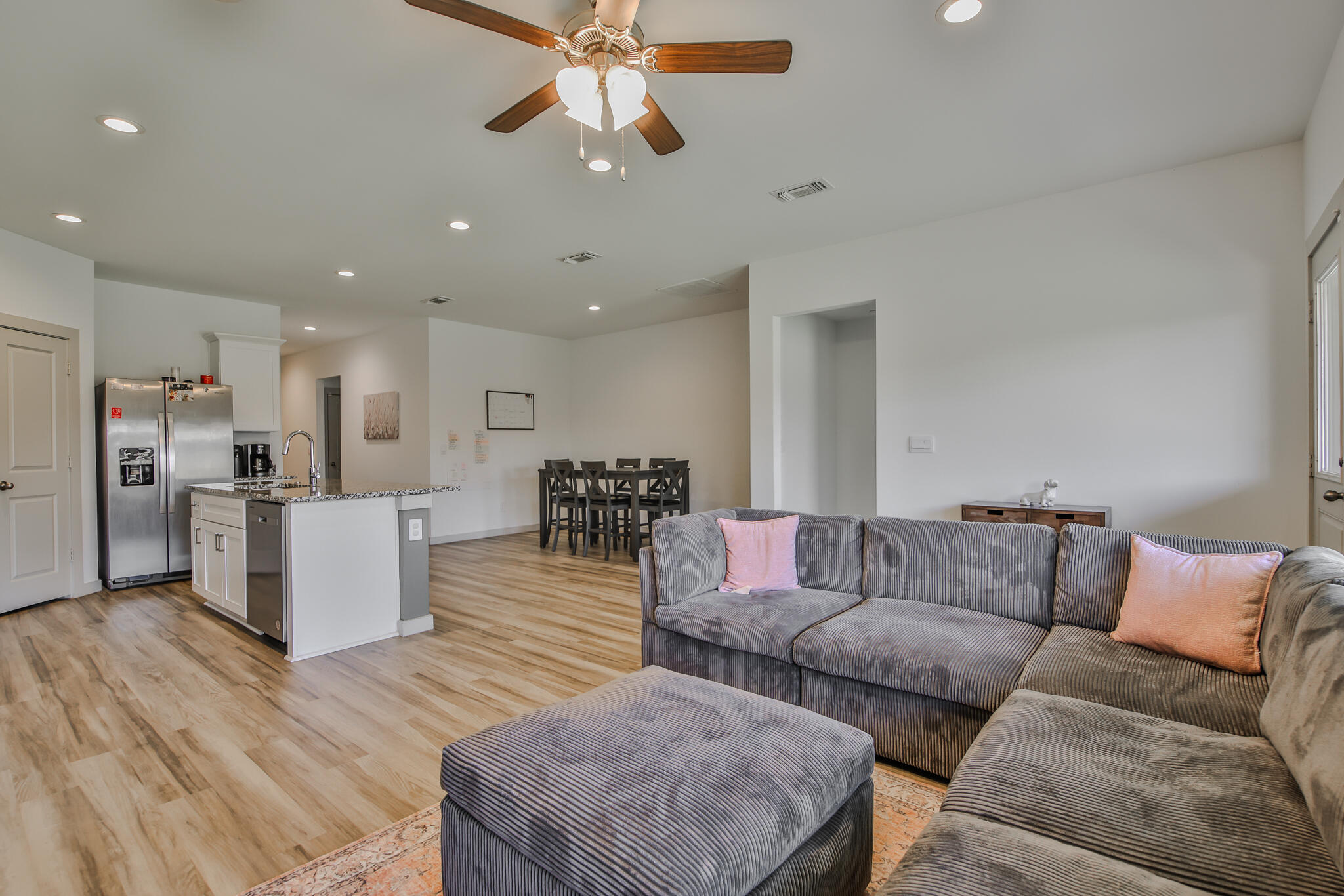 7406 9th Street Lubbock, TX 79416 - Photo 39 of 54 a living room with furniture kitchen view and a chandelier