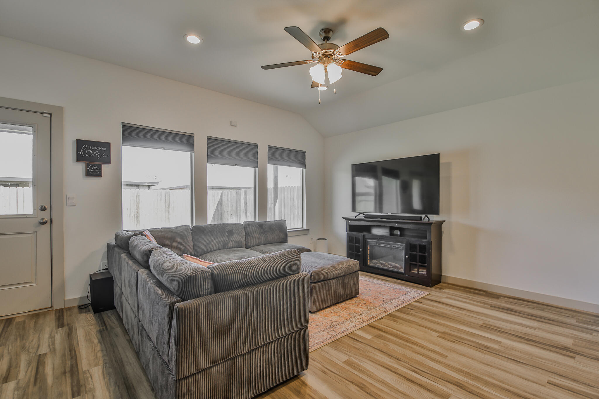 7406 9th Street Lubbock, TX 79416 - Photo 40 of 54 a living room with furniture and a flat screen tv