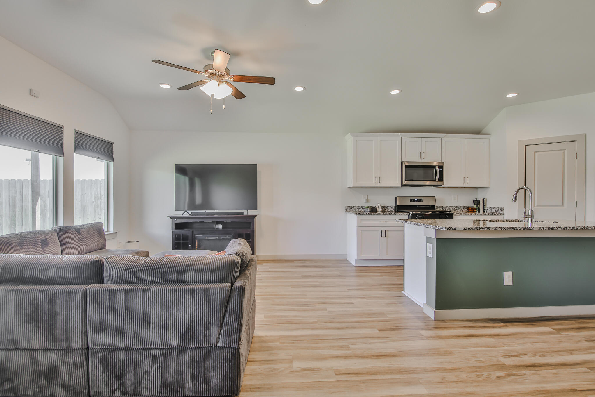 7406 9th Street Lubbock, TX 79416 - Photo 41 of 54 a living room with furniture and a flat screen tv