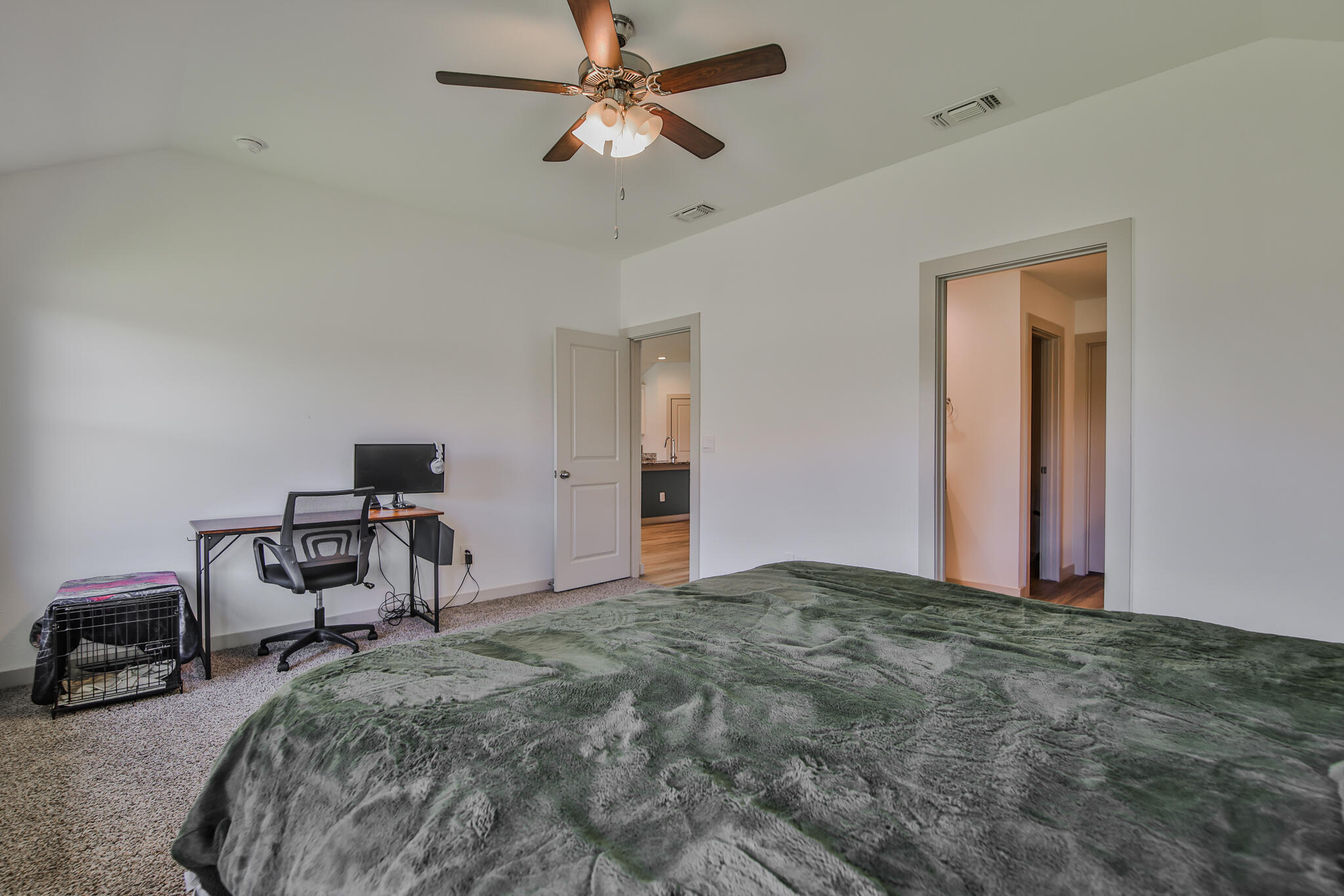 7406 9th Street Lubbock, TX 79416 - Photo 46 of 54 a bedroom with a bed and a chandelier