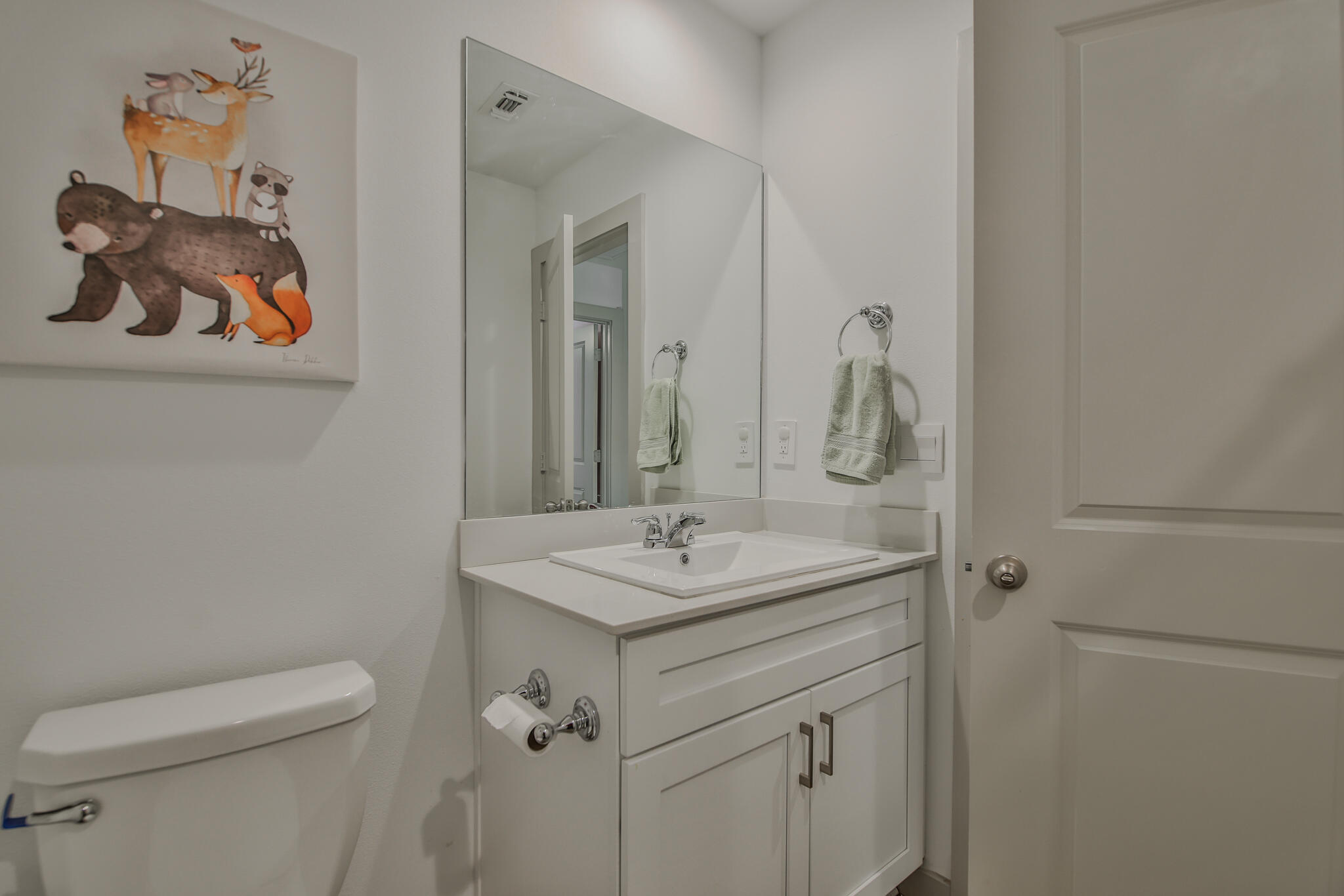7406 9th Street Lubbock, TX 79416 - Photo 10 of 54 a bathroom with a toilet sink and mirror