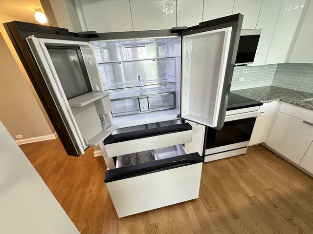 a view of kitchen with stainless steel appliances refrigerator and stove
