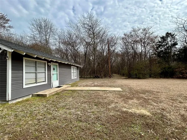 a house with trees in the background