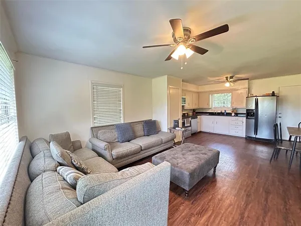a living room with furniture and wooden floor