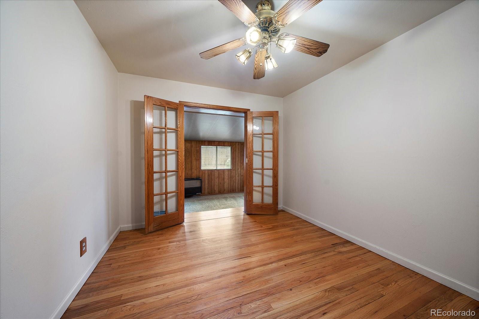2510 South Cherry Street Denver, CO 80222 - Photo 11 of 37 wooden floor in an empty room with a window