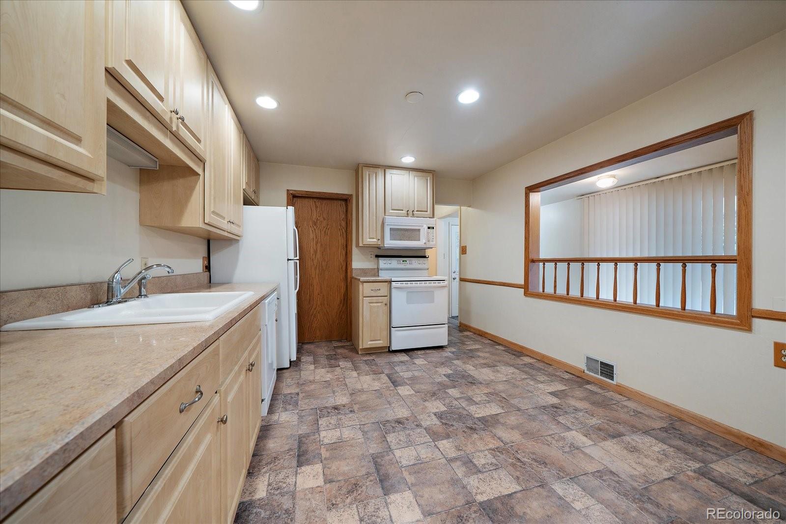 2510 South Cherry Street Denver, CO 80222 - Photo 13 of 37 a kitchen with cabinets and a refrigerator