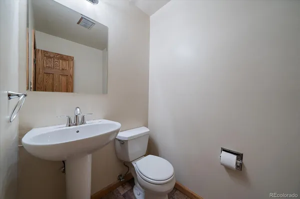 a white toilet sitting next to a bathroom sink
