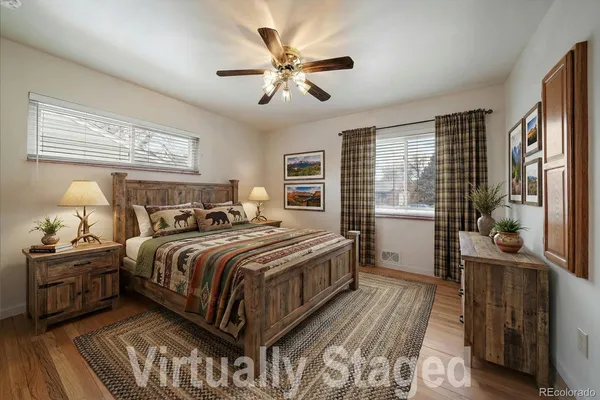 a bedroom with a large bed and a chandelier