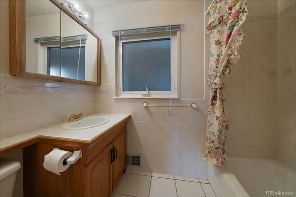 a bathroom with a sink a mirror and shower