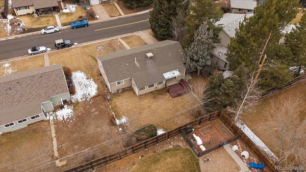an aerial view of a house with a yard