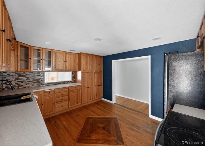 6498 South Turkey Creek Road Morrison, CO 80465 - Photo 7 of 19 a kitchen with granite countertop a refrigerator and a stove top oven