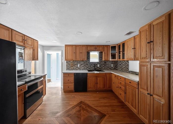6498 South Turkey Creek Road Morrison, CO 80465 - Photo 8 of 19 a kitchen with stainless steel appliances granite countertop a stove top oven a sink and dishwasher