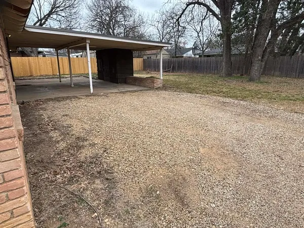 a backyard of a house with barbeque oven