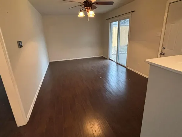 a view of a livingroom with wooden floor and staircase