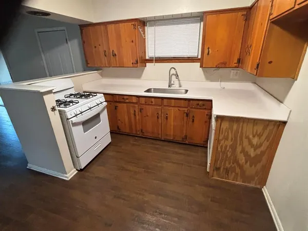 a kitchen with sink a cabinets and window