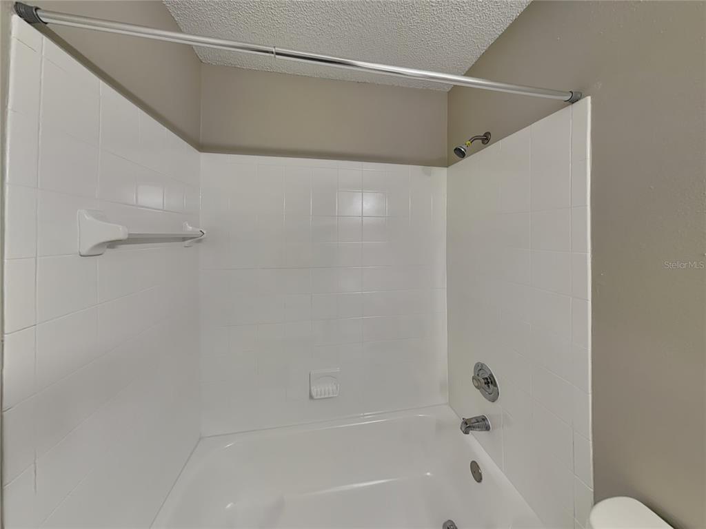 Undisclosed Address Deltona, FL 32738 - Photo 15 of 18 a bathroom with a shower and a bath tub