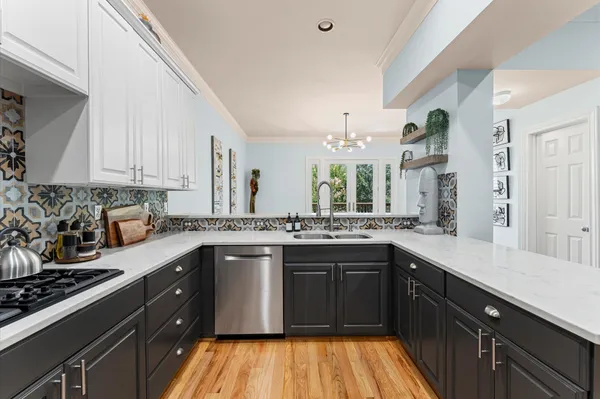 a kitchen with a sink stove and cabinets