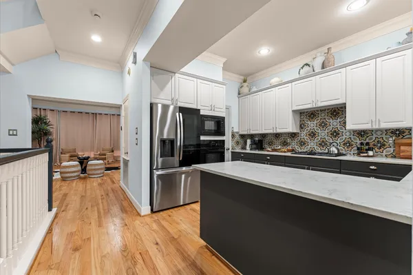 a kitchen with stainless steel appliances a refrigerator and a stove top oven