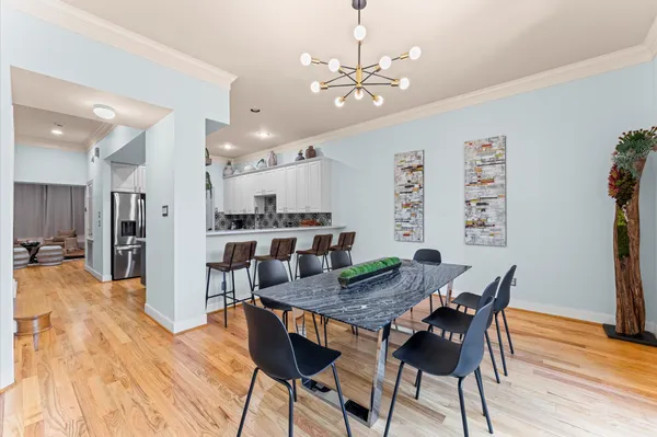 a view of a dining room with furniture and wooden floor
