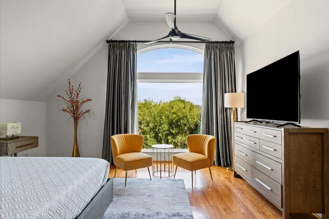 a bedroom with furniture and a flat screen tv