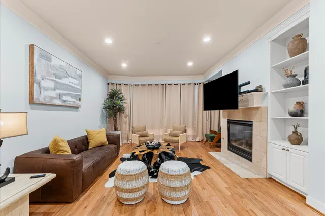 a living room with furniture a fireplace and a flat screen tv
