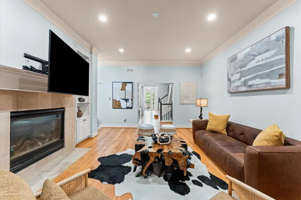 a living room with furniture a fireplace and a flat screen tv
