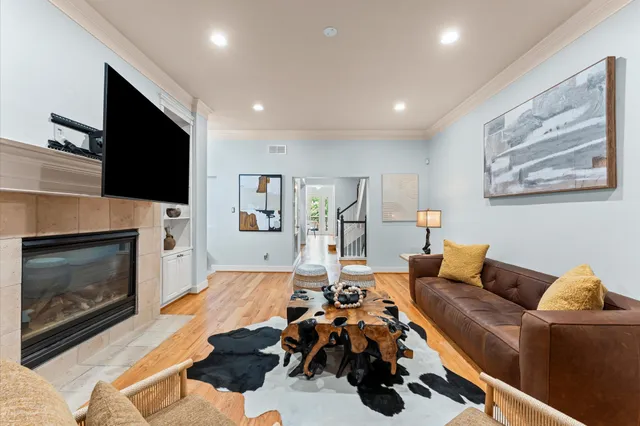 a living room with furniture a fireplace and a flat screen tv