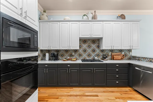a kitchen with stainless steel appliances granite countertop a stove and a sink