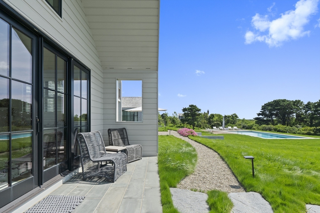 10 Maxey Pond Road Nantucket, MA 02554 - Photo 11 of 35 a front view of a house with garden