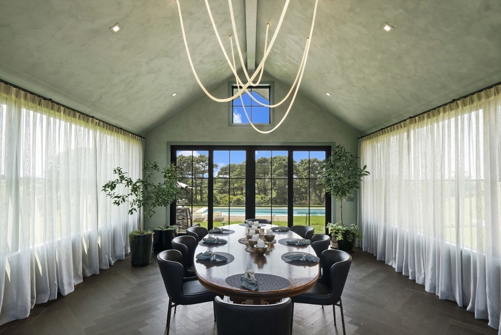 10 Maxey Pond Road Nantucket, MA 02554 - Photo 18 of 35 a dining room with furniture and a floor to ceiling window