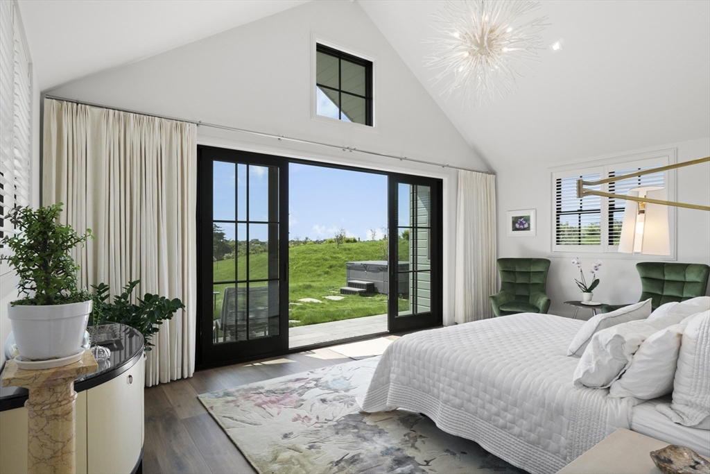 10 Maxey Pond Road Nantucket, MA 02554 - Photo 25 of 35 a bedroom with a bed and a potted plant