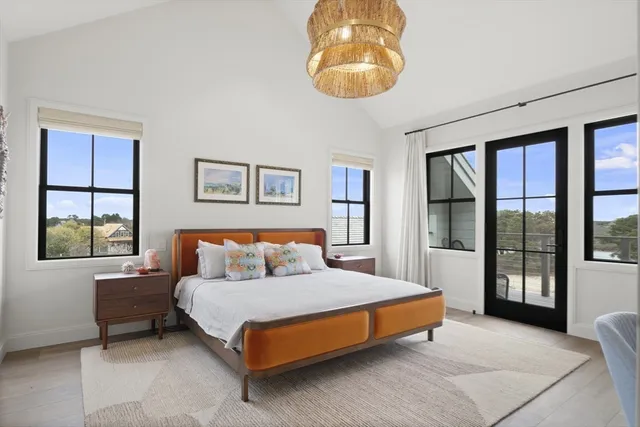 a spacious bedroom with a bed and glass window
