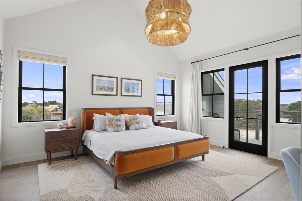 10 Maxey Pond Road Nantucket, MA 02554 - Photo 31 of 35 a spacious bedroom with a bed and glass window