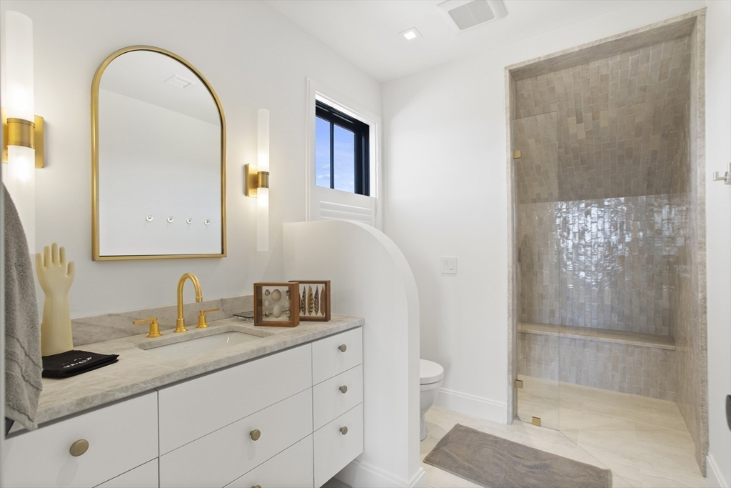 10 Maxey Pond Road Nantucket, MA 02554 - Photo 32 of 35 a bathroom with a granite countertop sink a toilet and a mirror