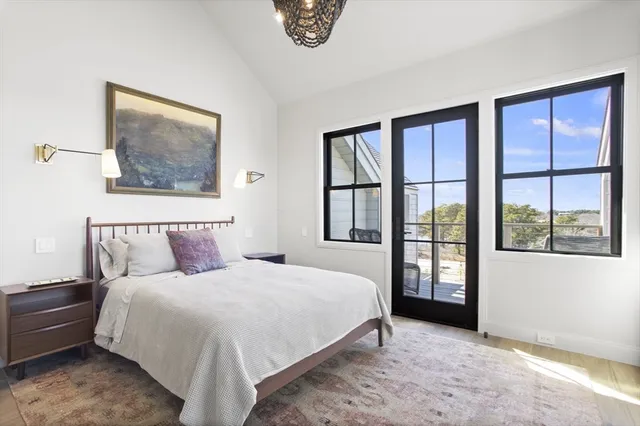 a bedroom with a large bed and a window