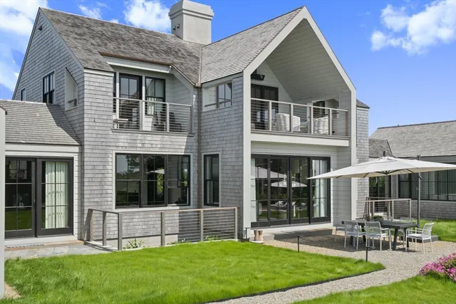 a front view of house with yard and outdoor seating