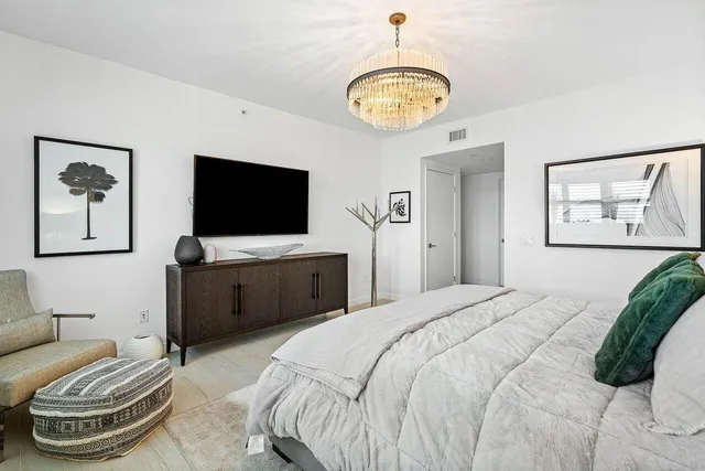 a bedroom with a bed and a flat screen tv
