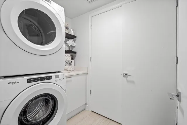 a view of a hallway with washer and dryer