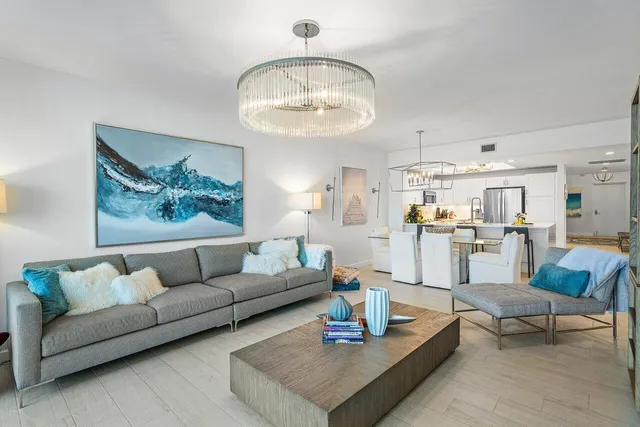 a living room with furniture and a view of kitchen