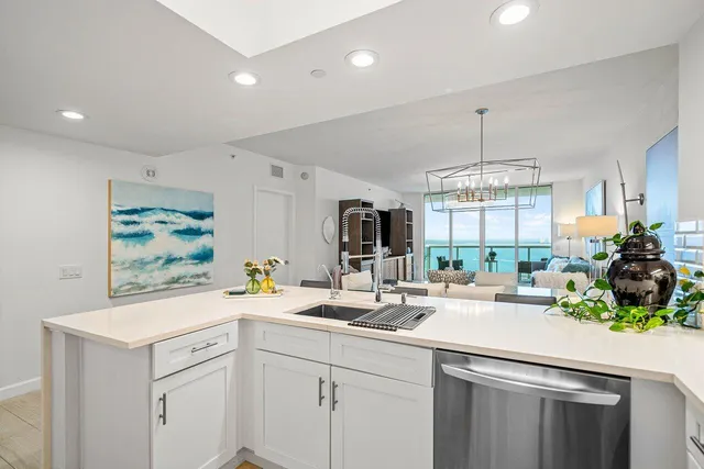 a kitchen with a sink stainless steel appliances and cabinets