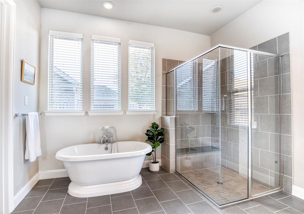 5904 Rutland Road McKinney, TX 75070 - Photo 17 of 40 Bathroom featuring tile patterned flooring, a stall shower, and a freestanding tub