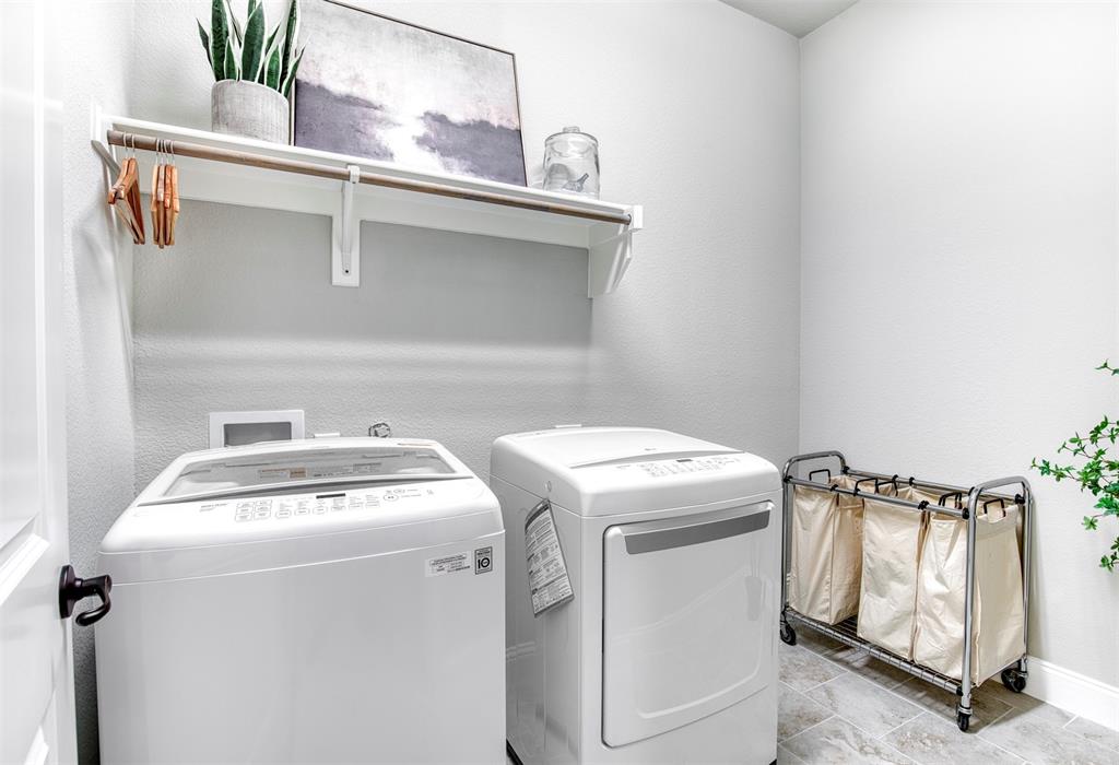 5904 Rutland Road McKinney, TX 75070 - Photo 20 of 40 Laundry area with washing machine and clothes dryer and a textured wall
