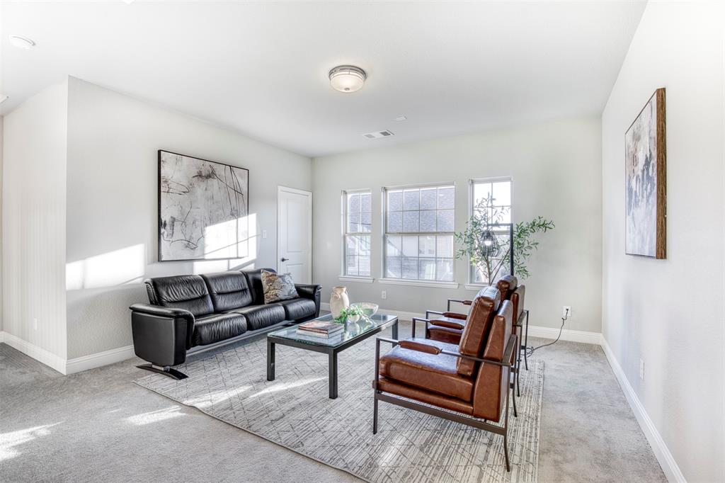 5904 Rutland Road McKinney, TX 75070 - Photo 23 of 40 Carpeted living area featuring baseboards