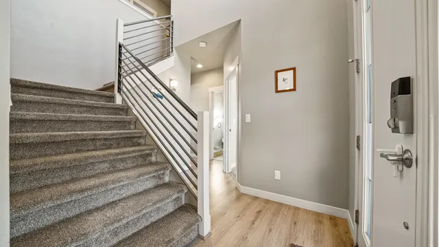 a view of a hallway with wooden floor and entryway