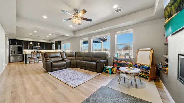 a living room with furniture and wooden floor