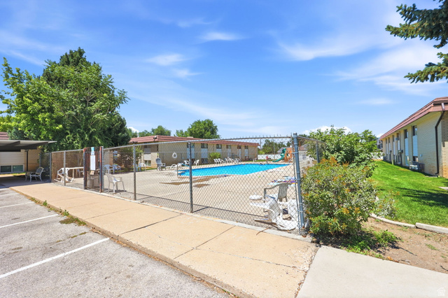 314 West Center Street, Unit F102 Bountiful, UT 84010 - Photo 21 of 29 Outdoor swimming pool area featuring a chain-link fence enclosure