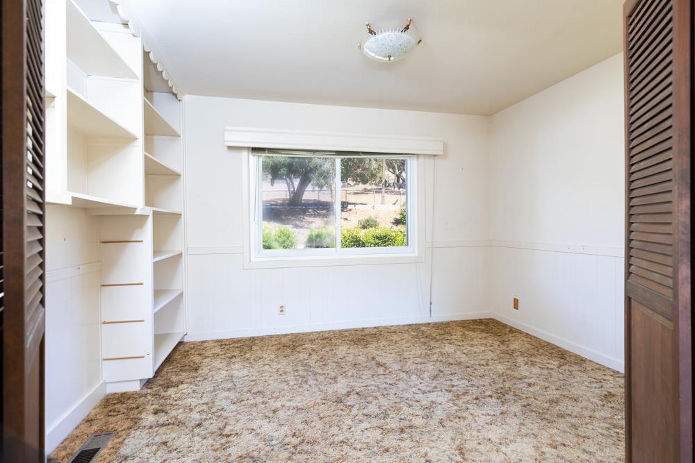 417 Maher Road Watsonville, CA 95076 - Photo 7 of 37 en empty room with window and ceiling fan