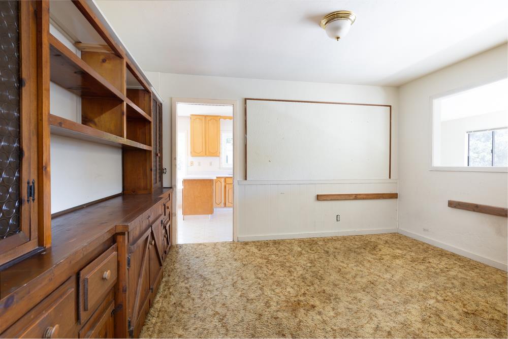 417 Maher Road Watsonville, CA 95076 - Photo 8 of 37 a view of an empty room with wooden floor and windows